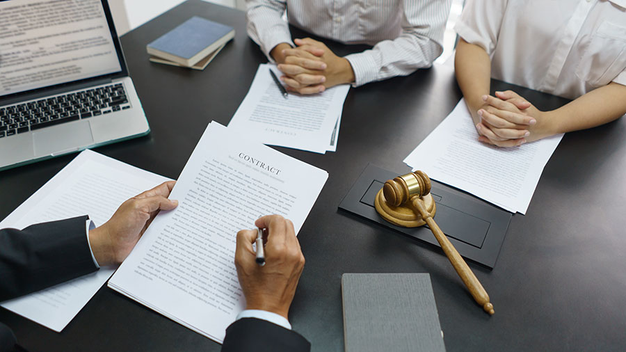 A man and woman consulting a lawyer on child custody in the midst of a divorce