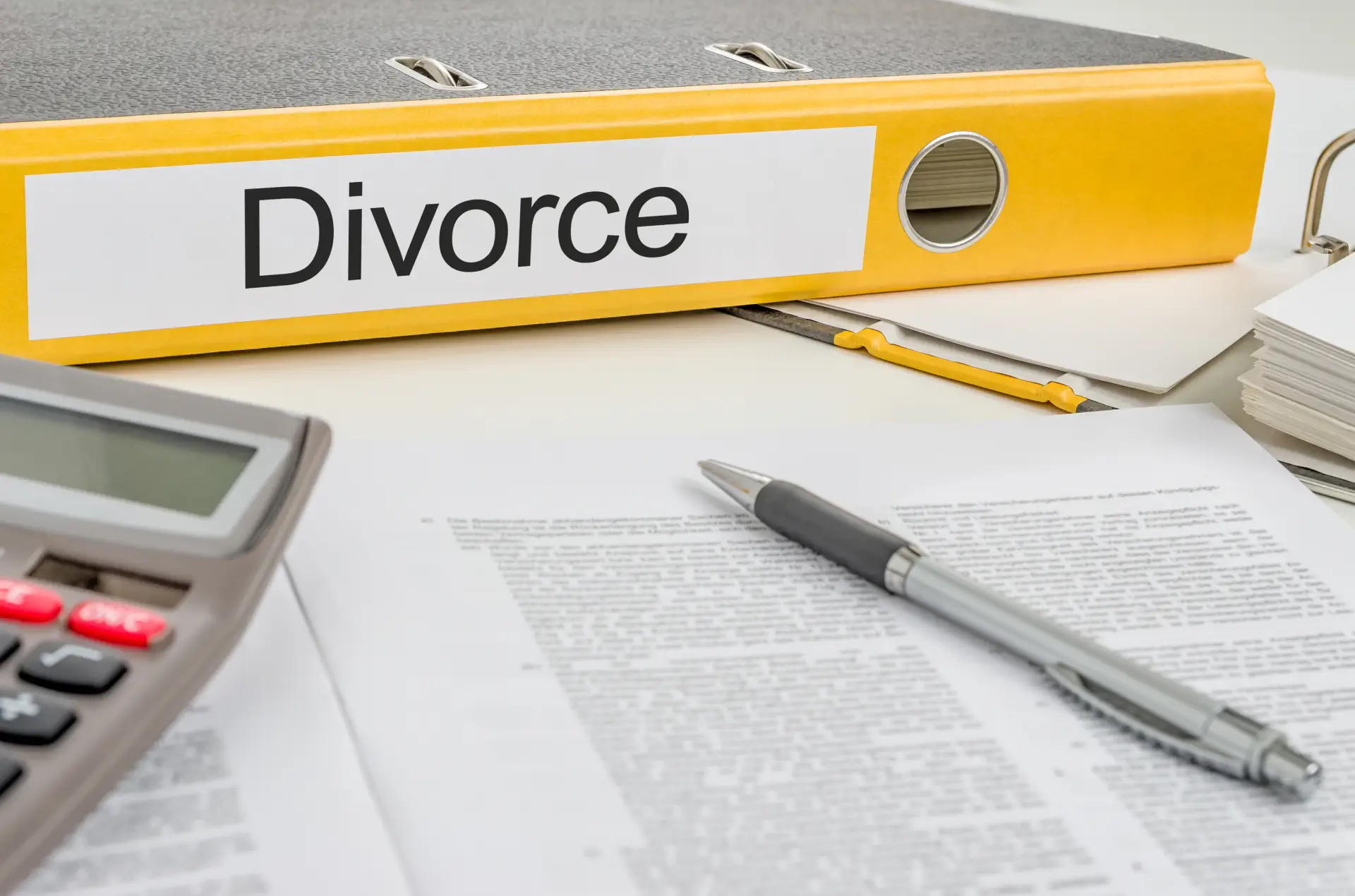 Stack of divorce documents, files, and legal papers for filing a divorce in Singapore.